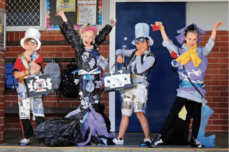 Children celebrating while wearing rubbish