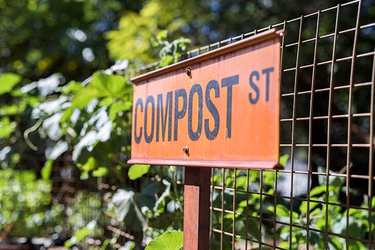 novelty garden sign with the word 'compost st'