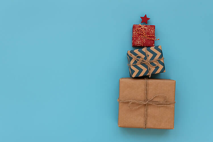 brightly wrapped presents stacked into a christrams tree shape