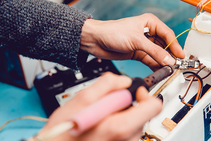 Person fusing wires in household item