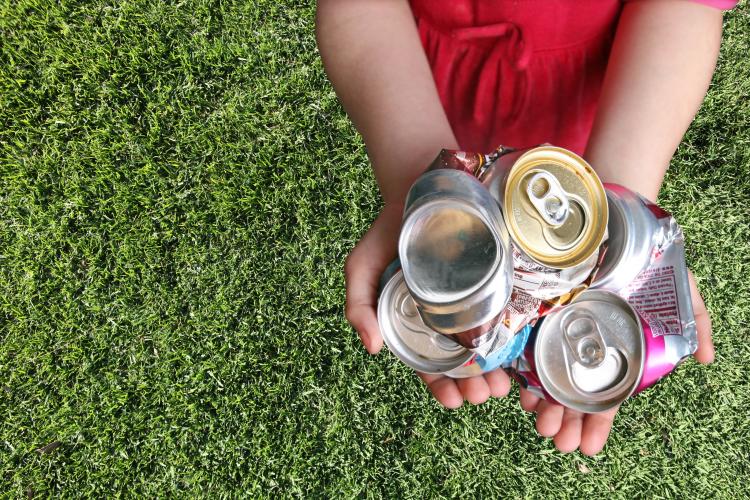 Child holding cans
