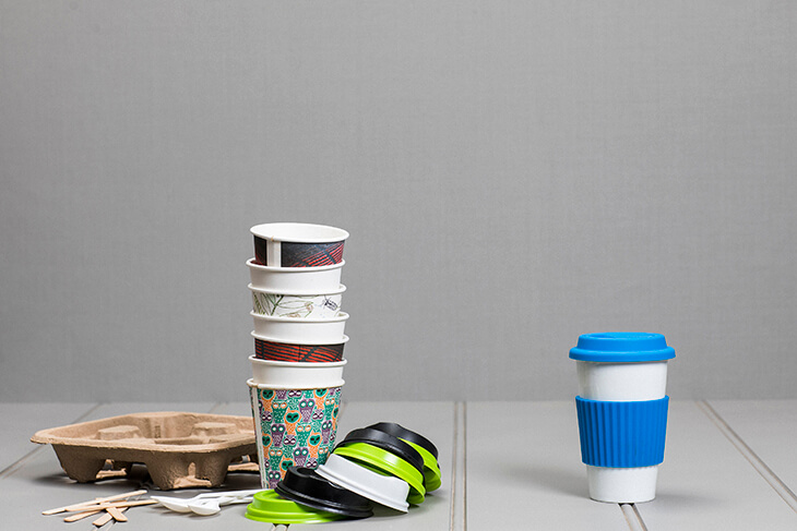 bunch of disposible cups next to a single reusable cup