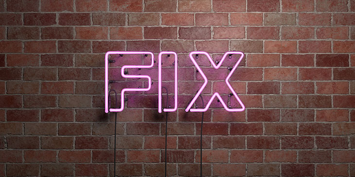 Neon sign on brick wall spelling the word FIX