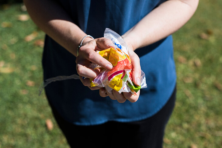 close up of hands with scrunched up plastics