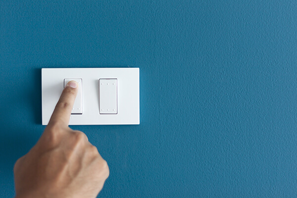 close up of hand flicking a light switch