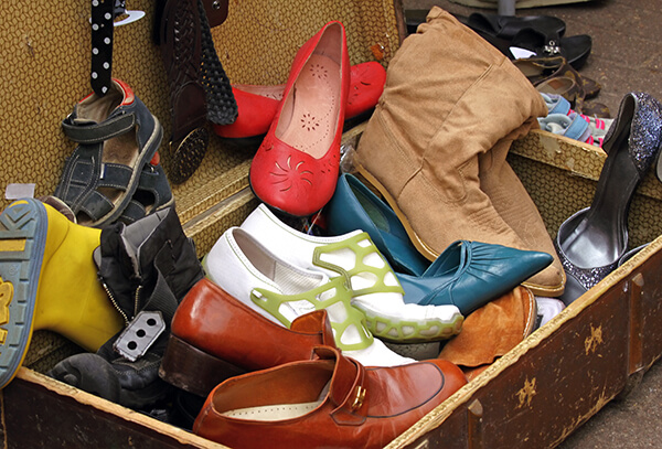 suitcase filled with secondhand shoes