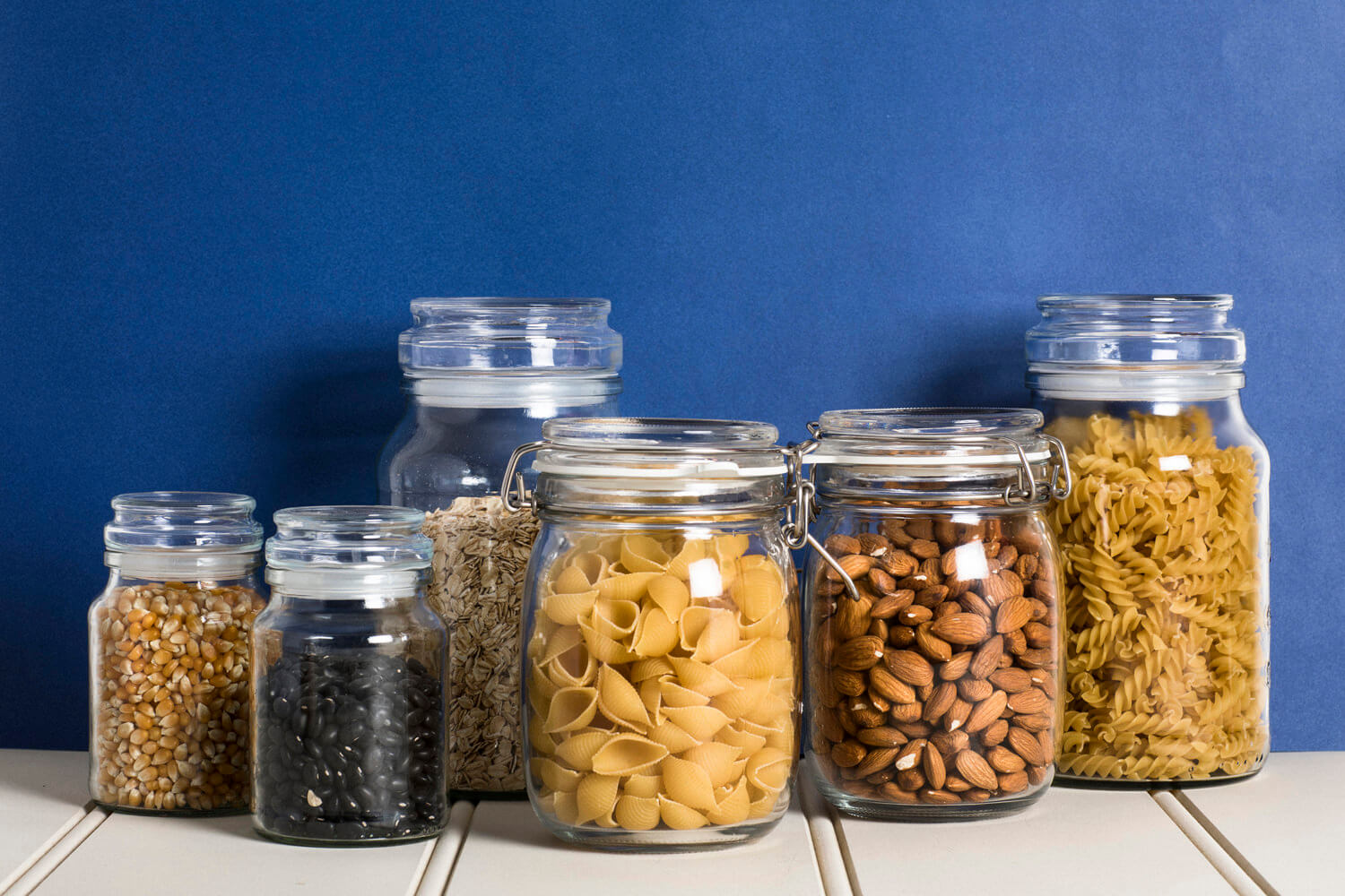 assortment of dried goods in glass jars