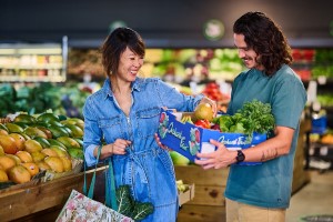 Two people hold reusable food and drink containers